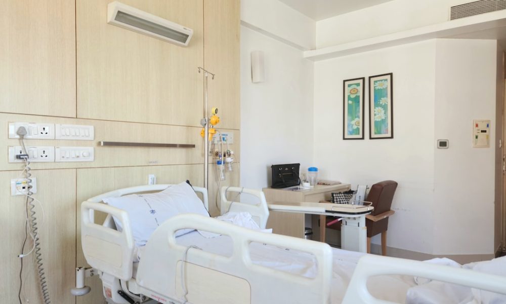 a hospital room with empty beds and medical equipment