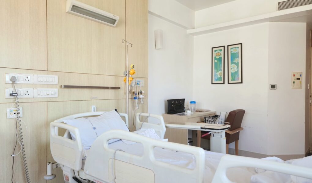 a hospital room with empty beds and medical equipment