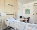a hospital room with empty beds and medical equipment